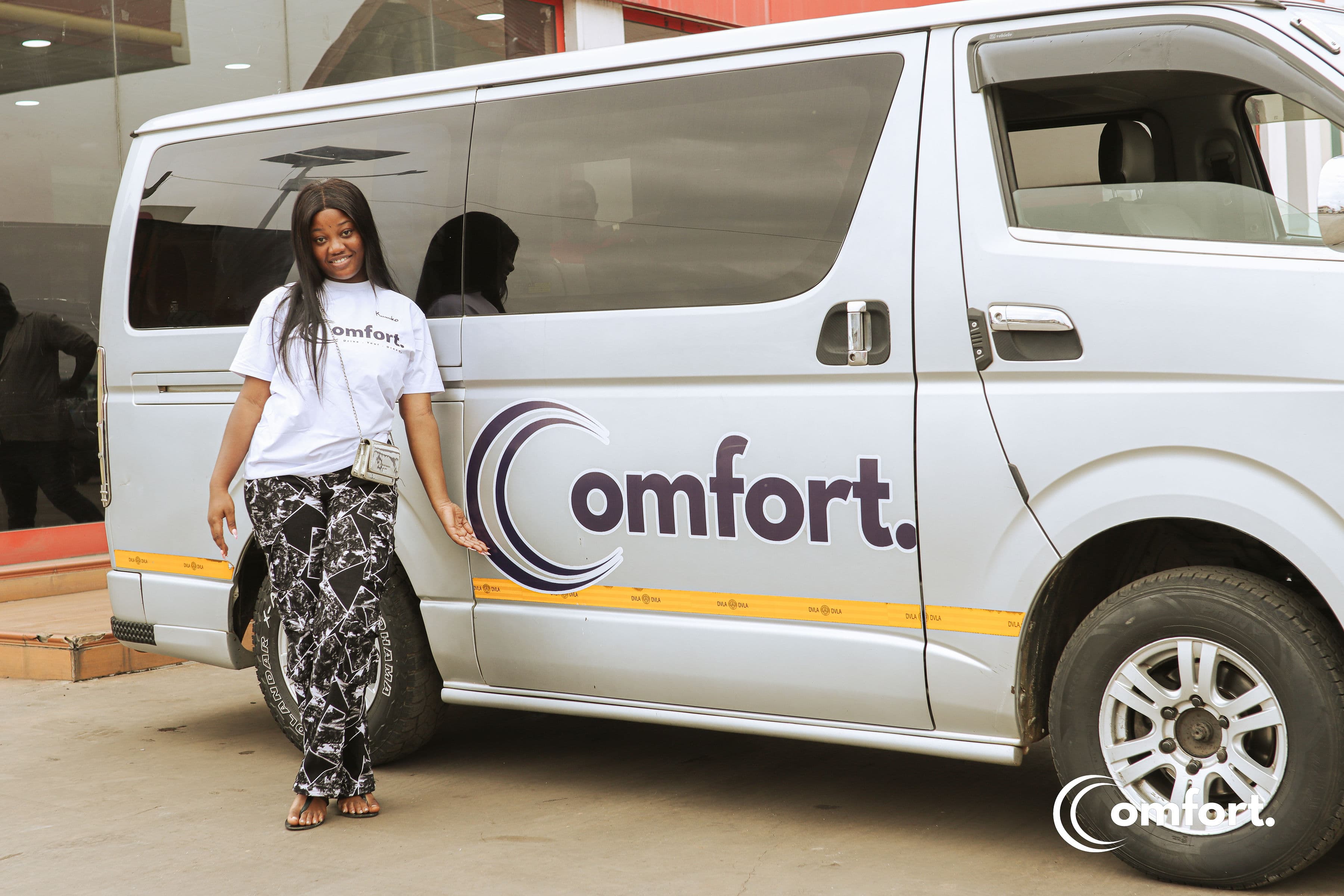 Comfort team member standing next to a Comfort vehicle