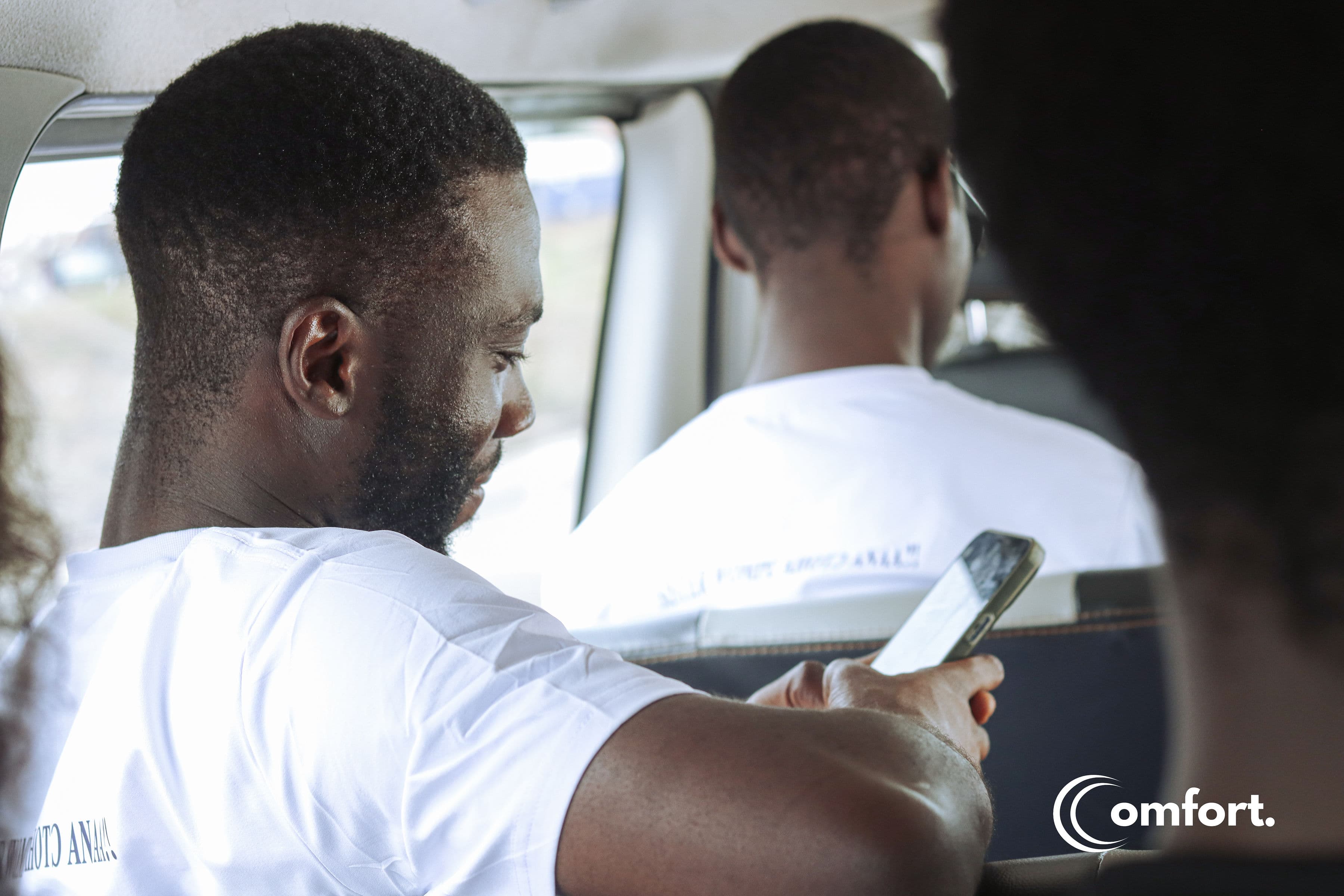 Comfort team member on phone in vehicle